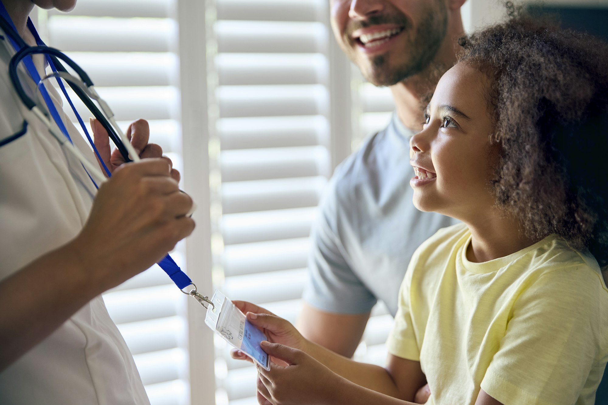 Close Up Of Girl Looking At Nurse's Security Lanyard