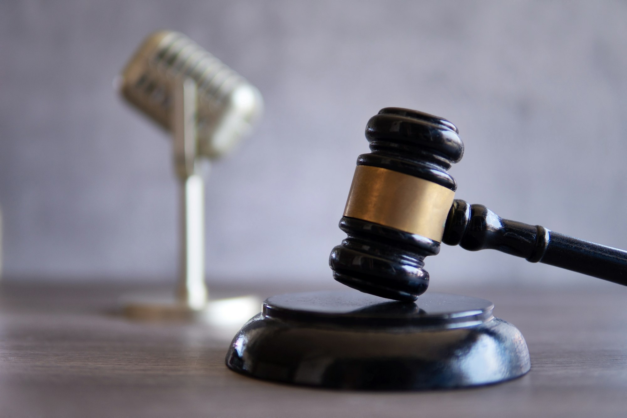 Closeup image of microphone and judge gavel.