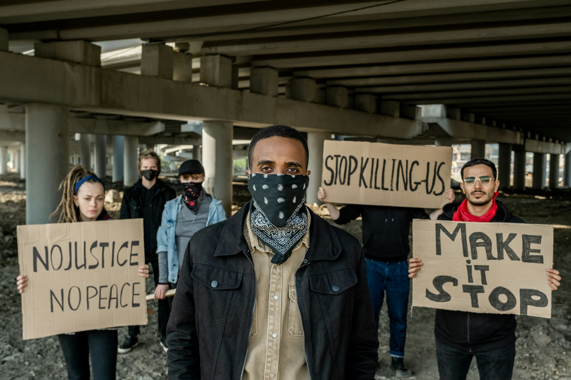 Group of extremists with banners under bridge